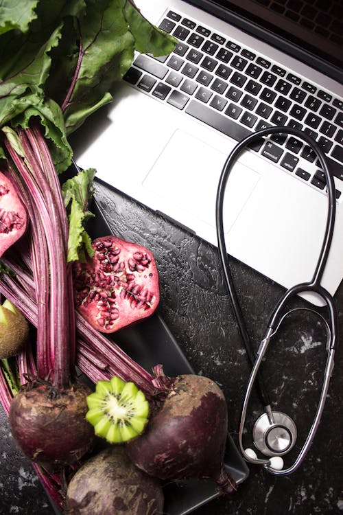 a laptop computer and a stethoscope on a table