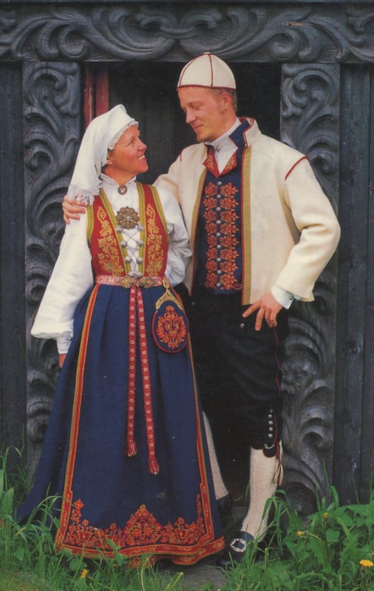 A woman and a man looking at each other in bunad