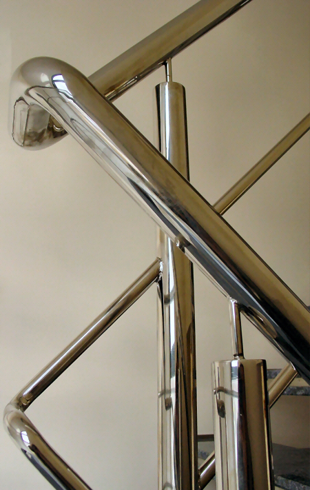 a metal stair case with a metal handrail