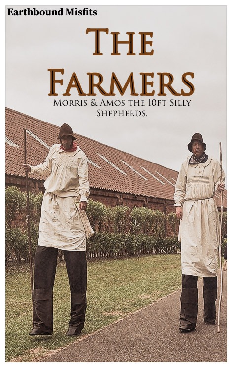 Two Earthbound Misfits performers on 10ft stilts dressed as silly shepherd farmers.