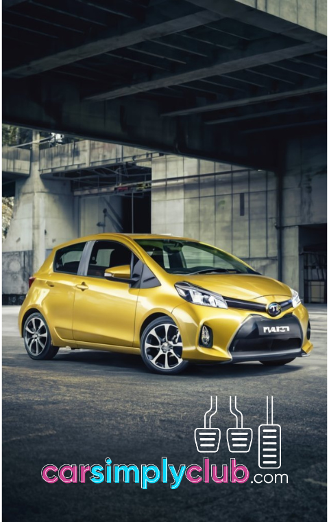 a yellow toyota yaris hatchback parked in front of a building