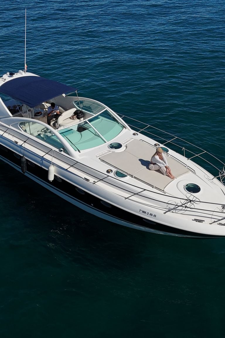 a boat with a man sitting on the water