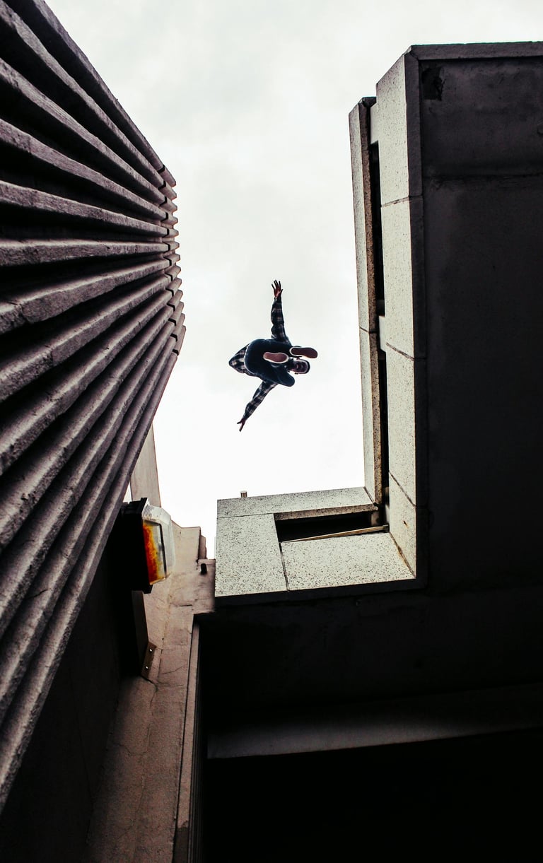 Dancer jumping between buildings