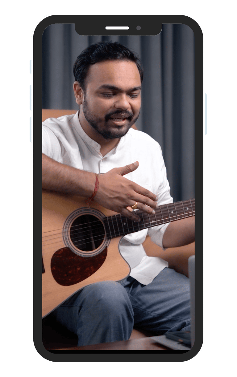 Music teacher teaching guitar on online class on mobile phone