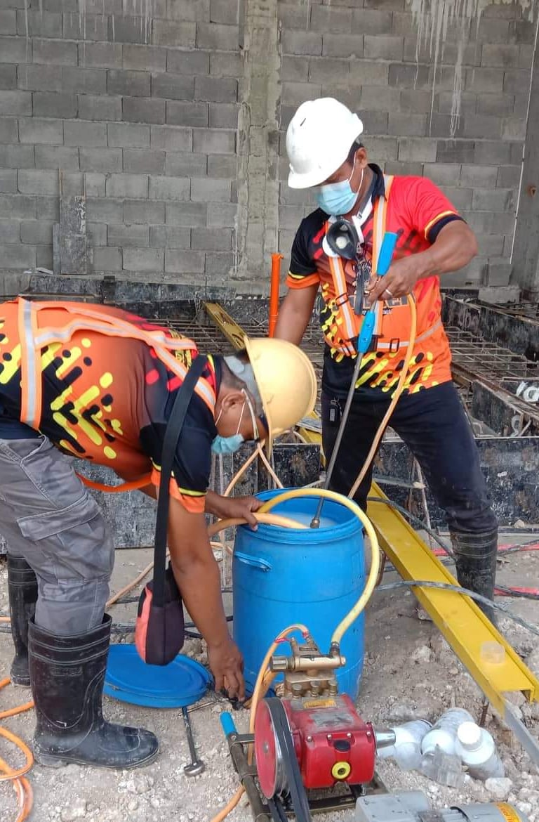 Technician from Jansen Pest Control performing soil poisoning