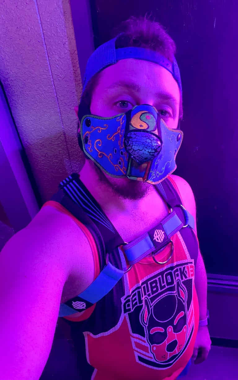 Man in a half-pup mask in a club.