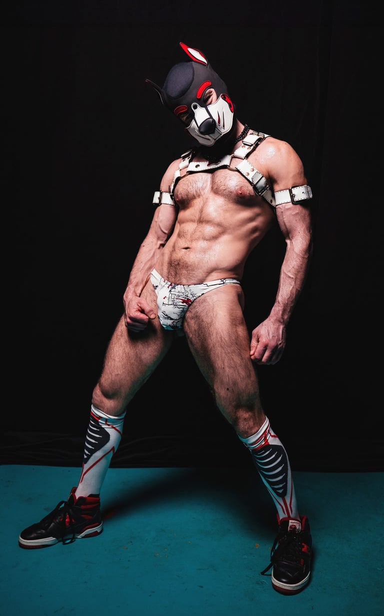 Man in harness and pup mask.