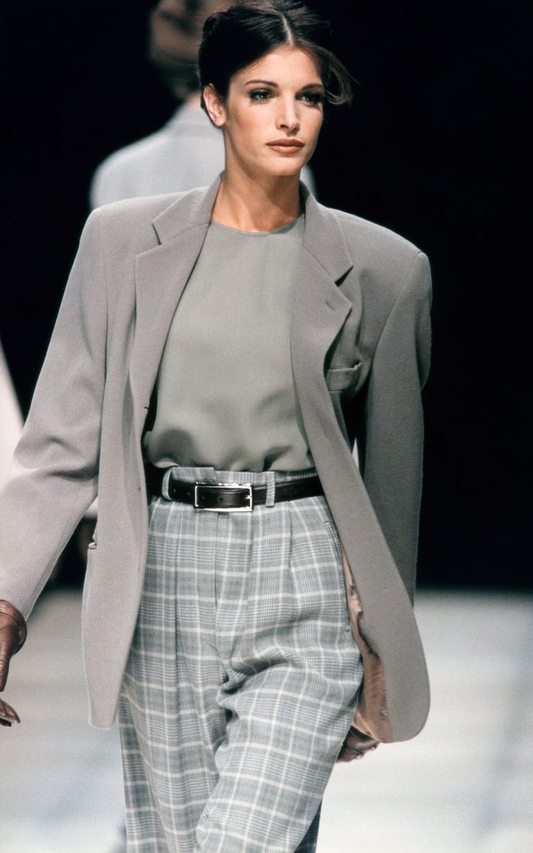 Model in greige Giorgio Armani suit demonstrating fluid tailoring and quiet luxury.