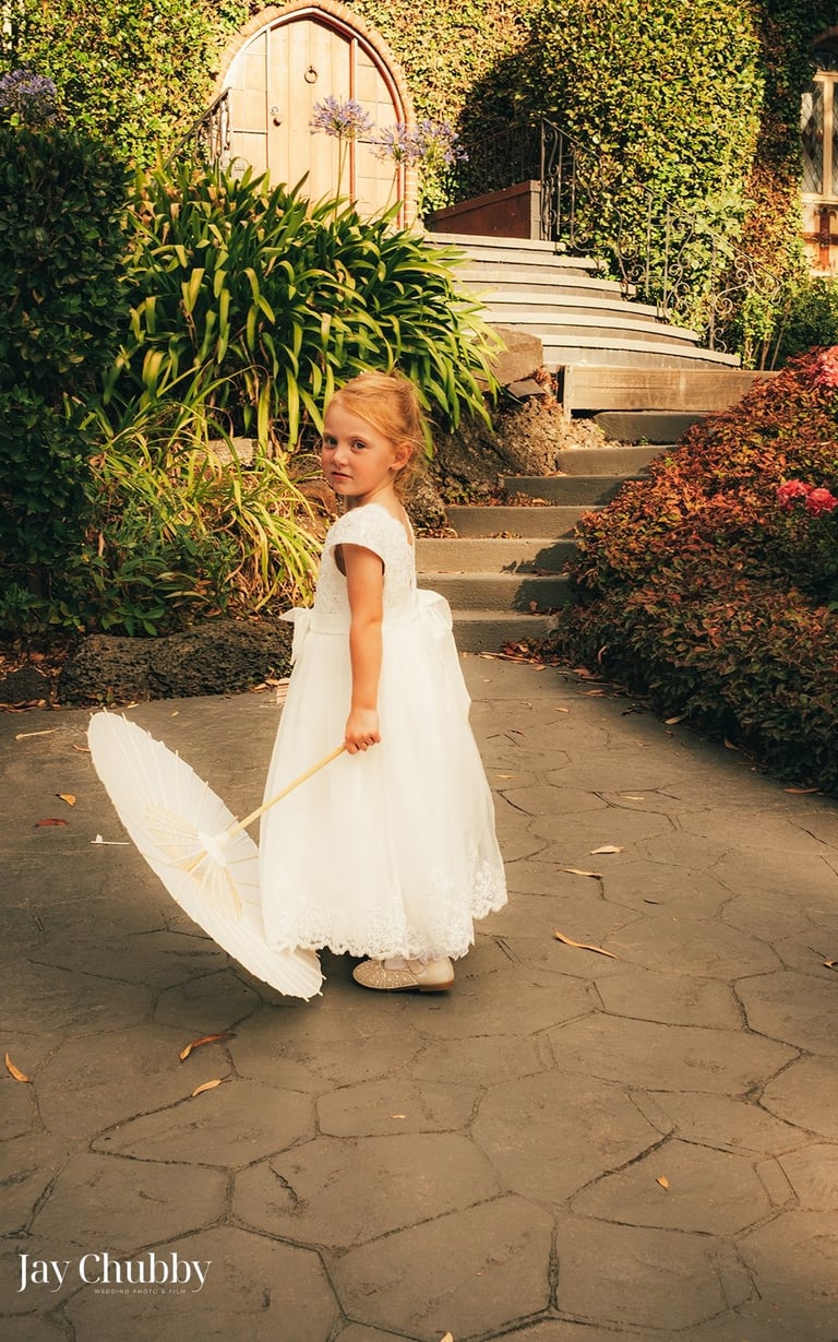 Flower girl portrait with parasol Avalon Castle Melbourne wedding garden path