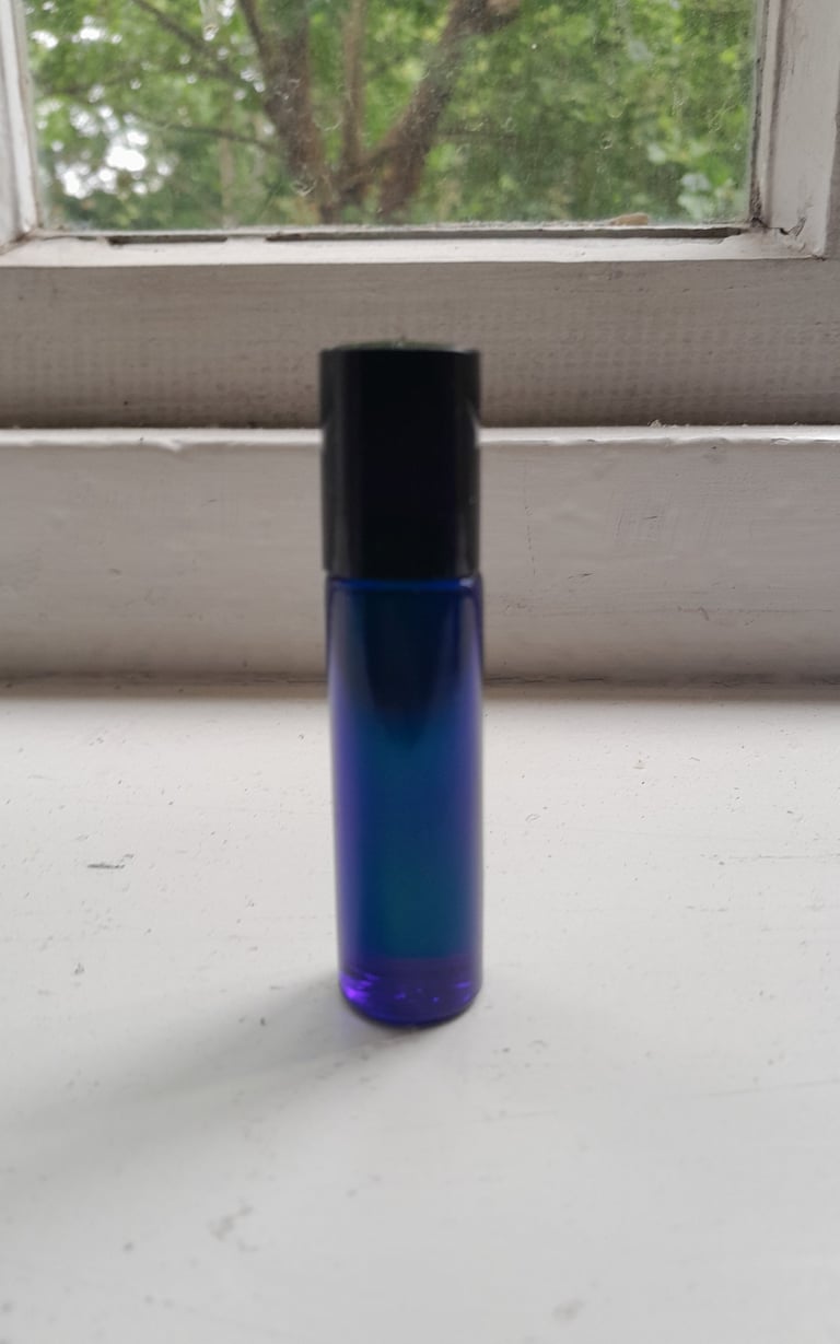 An image of a homemade aromatherapy perfume called Roller Ball Pulse Point in a blue spray bottle.