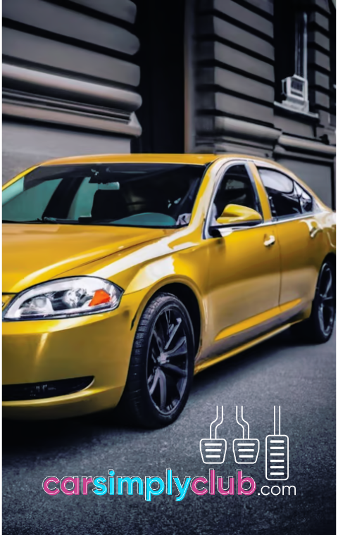 a yellow Chevrolet Impala parked on the side of a street