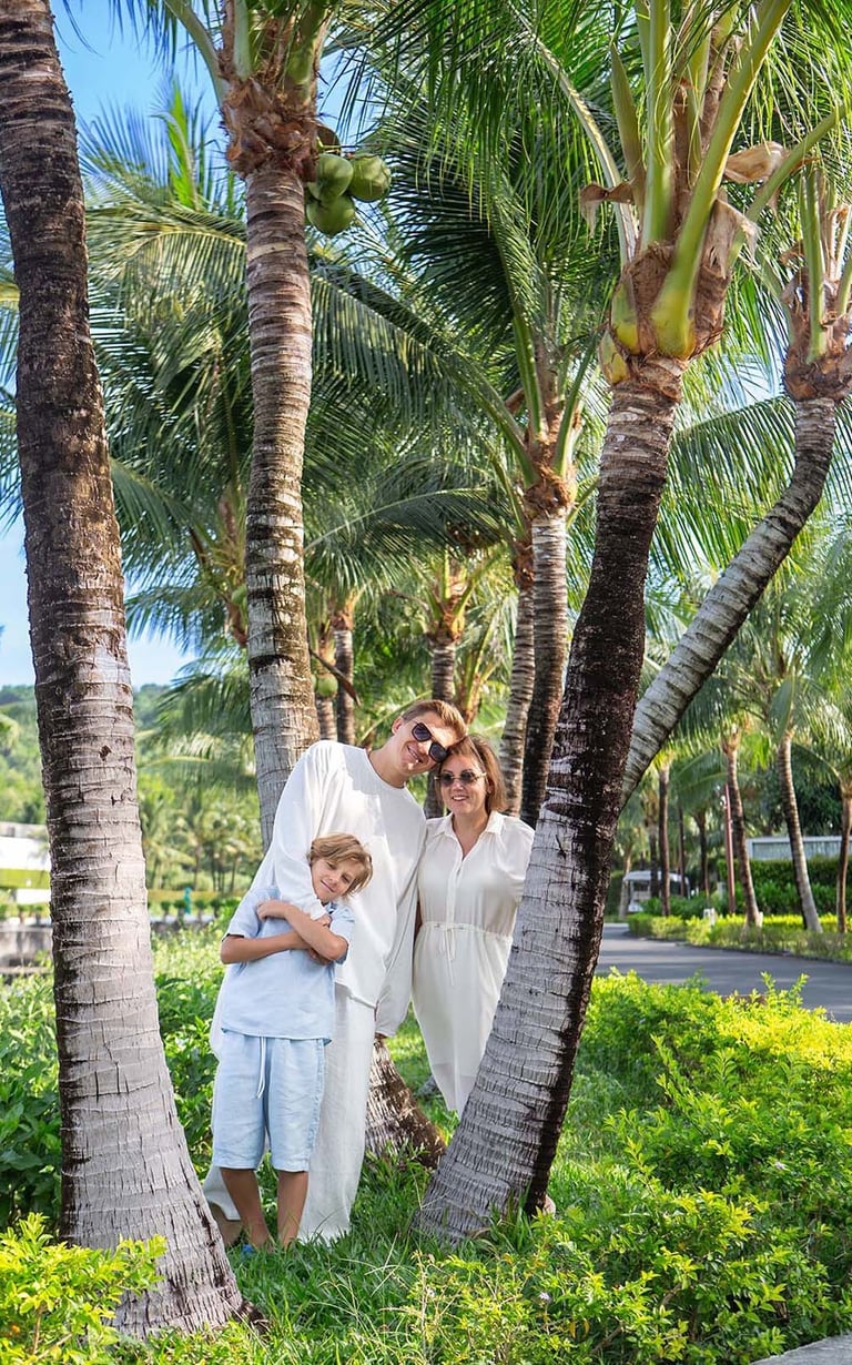 Family portrait under coconut palms at Radisson Blu resort