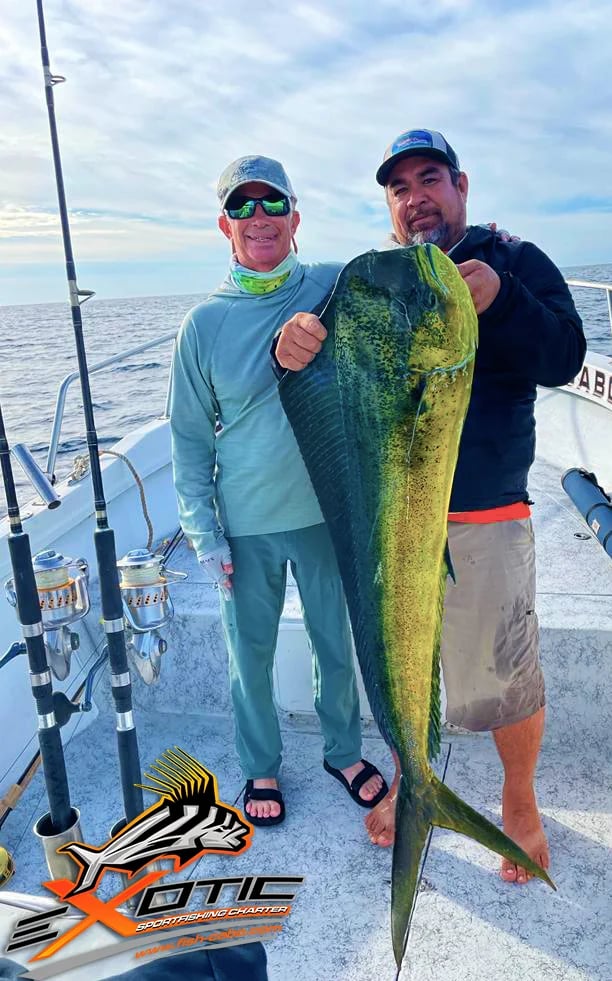 a man holding a fish on a boat