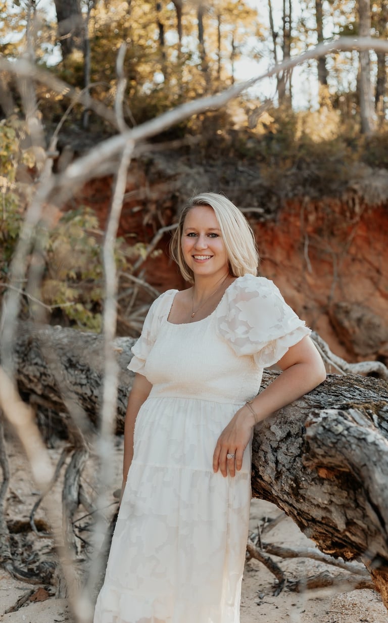 Picture of Emily by a fallen tree
