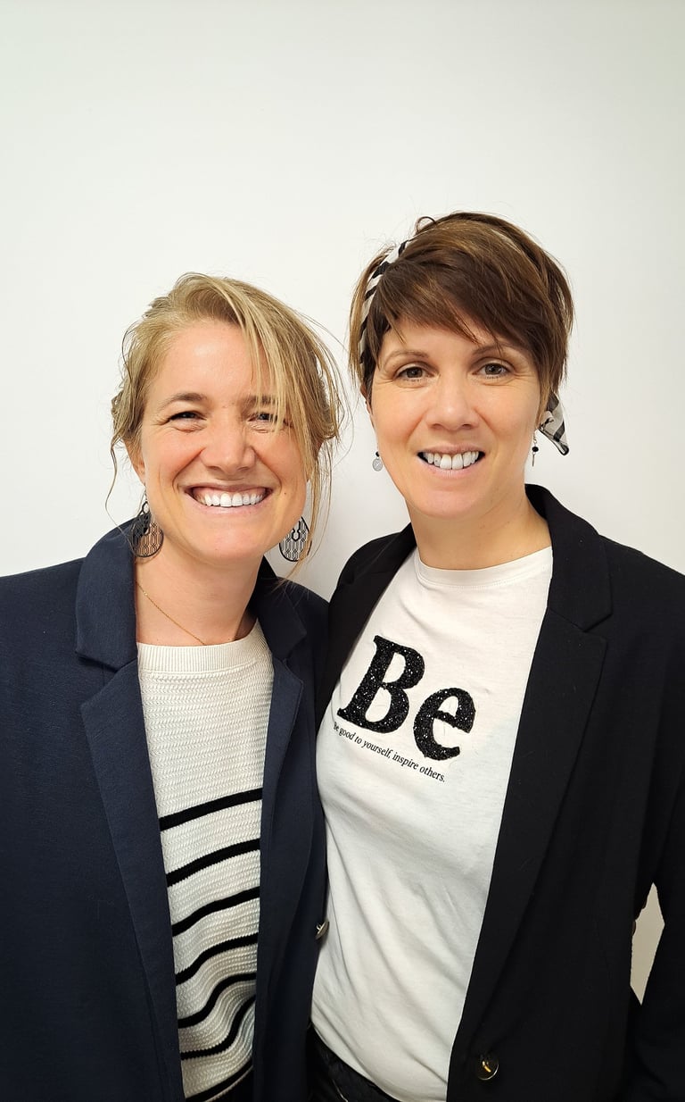 deux femmes debout l'une à côté de l'autre dans une pièce