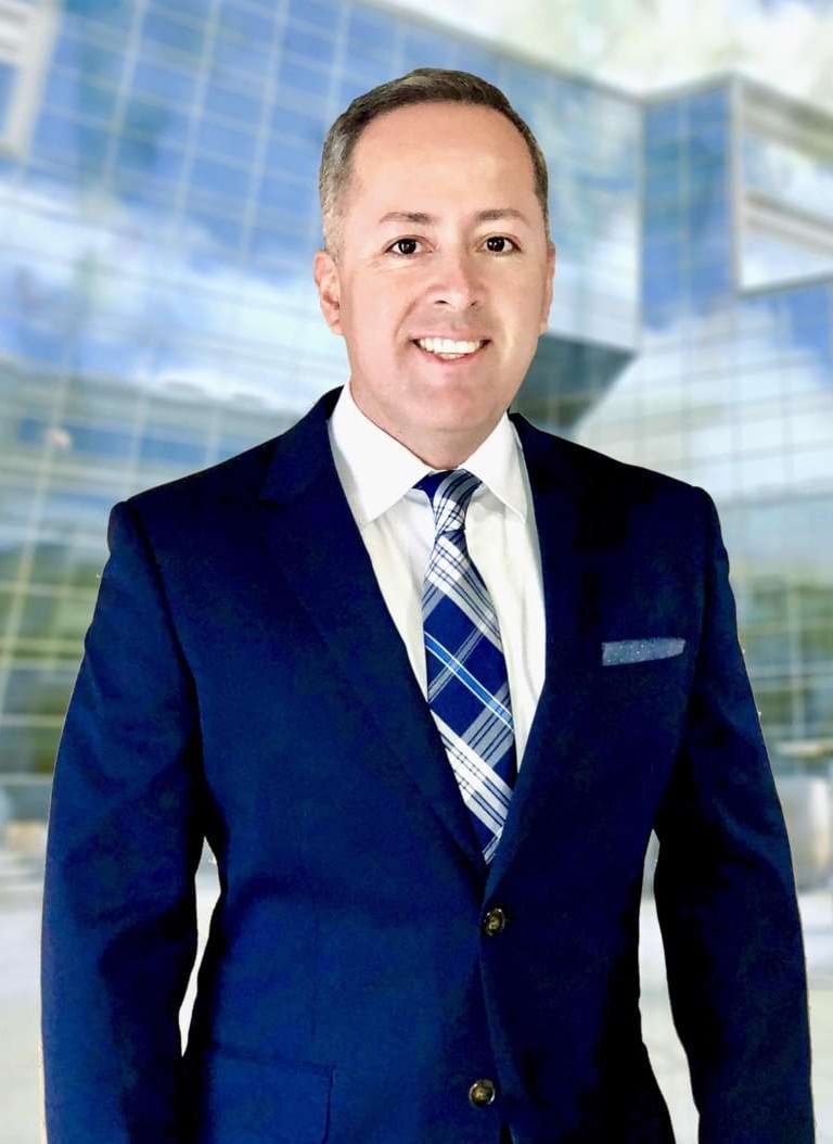 a man in a suit and tie smiling