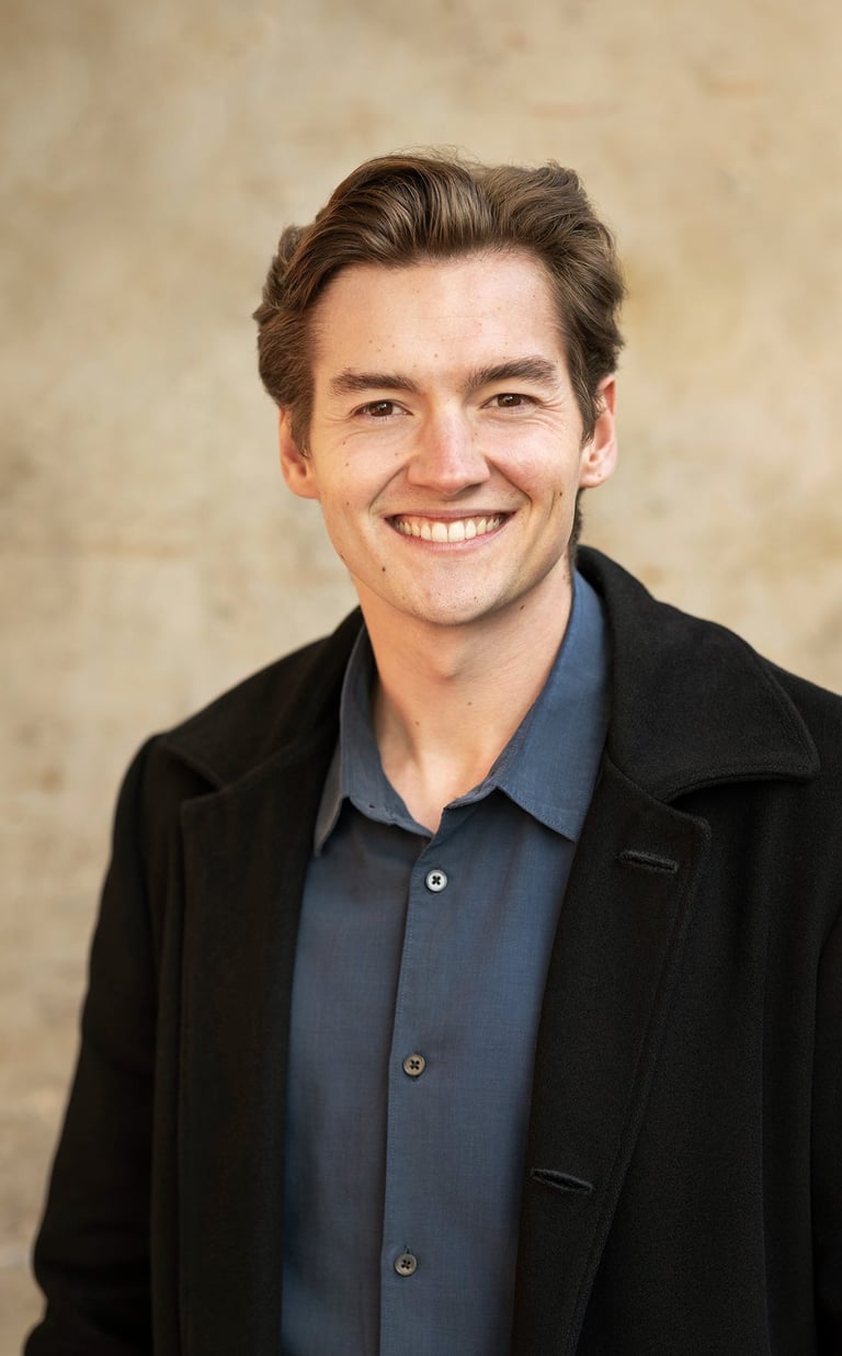 a man in a black jacket and a blue shirt