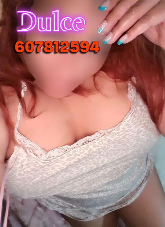 a woman with red hair and a white bra