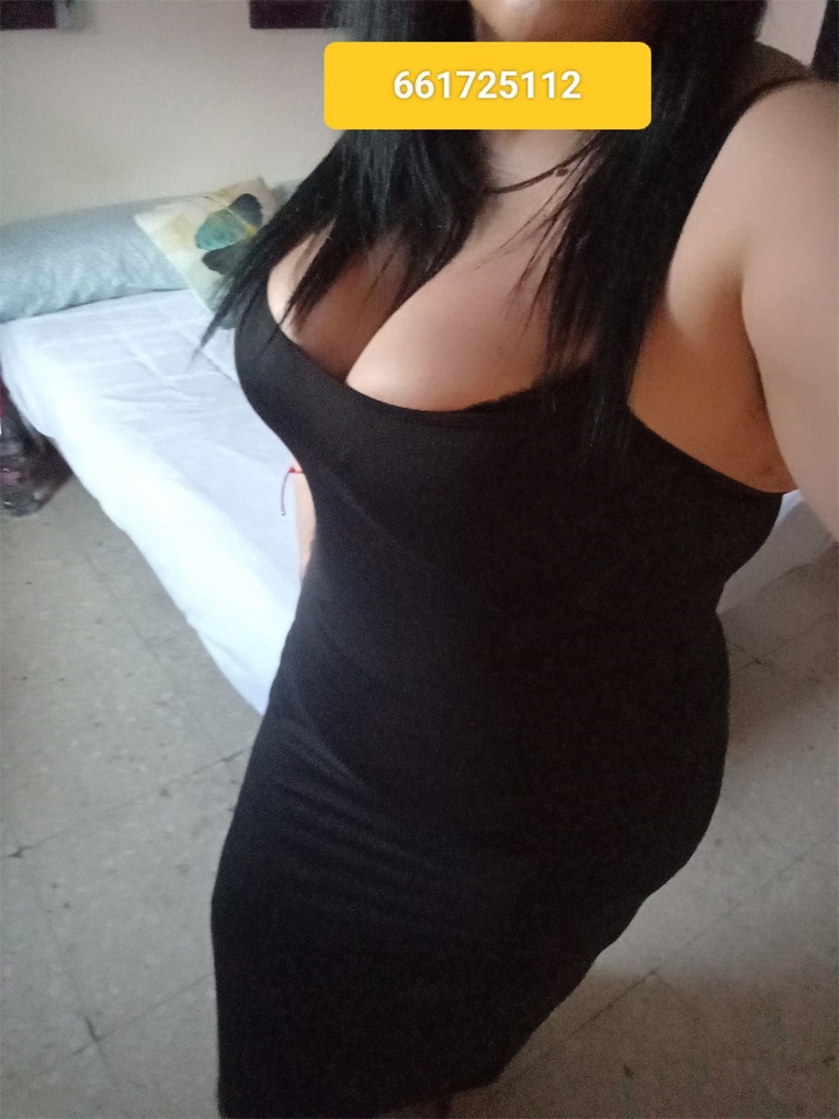 a woman in a black dress with a yellow tag on her chest
