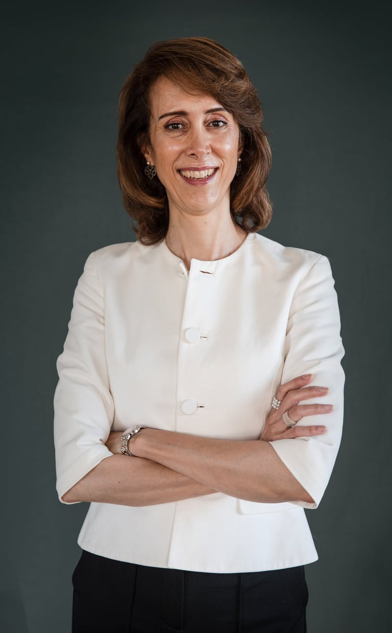 a female life coach in a white jacket and black pants