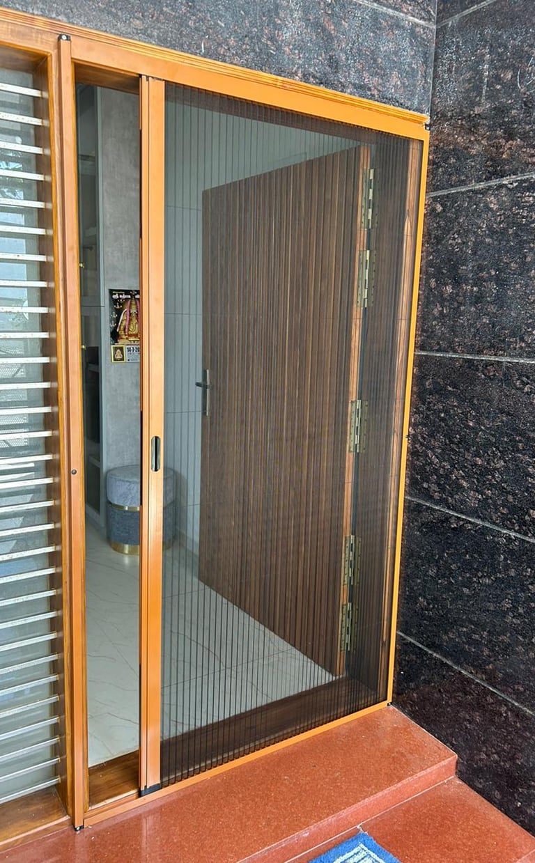 Retractable pleated mosquito net installed on a wooden door frame for insect protection.