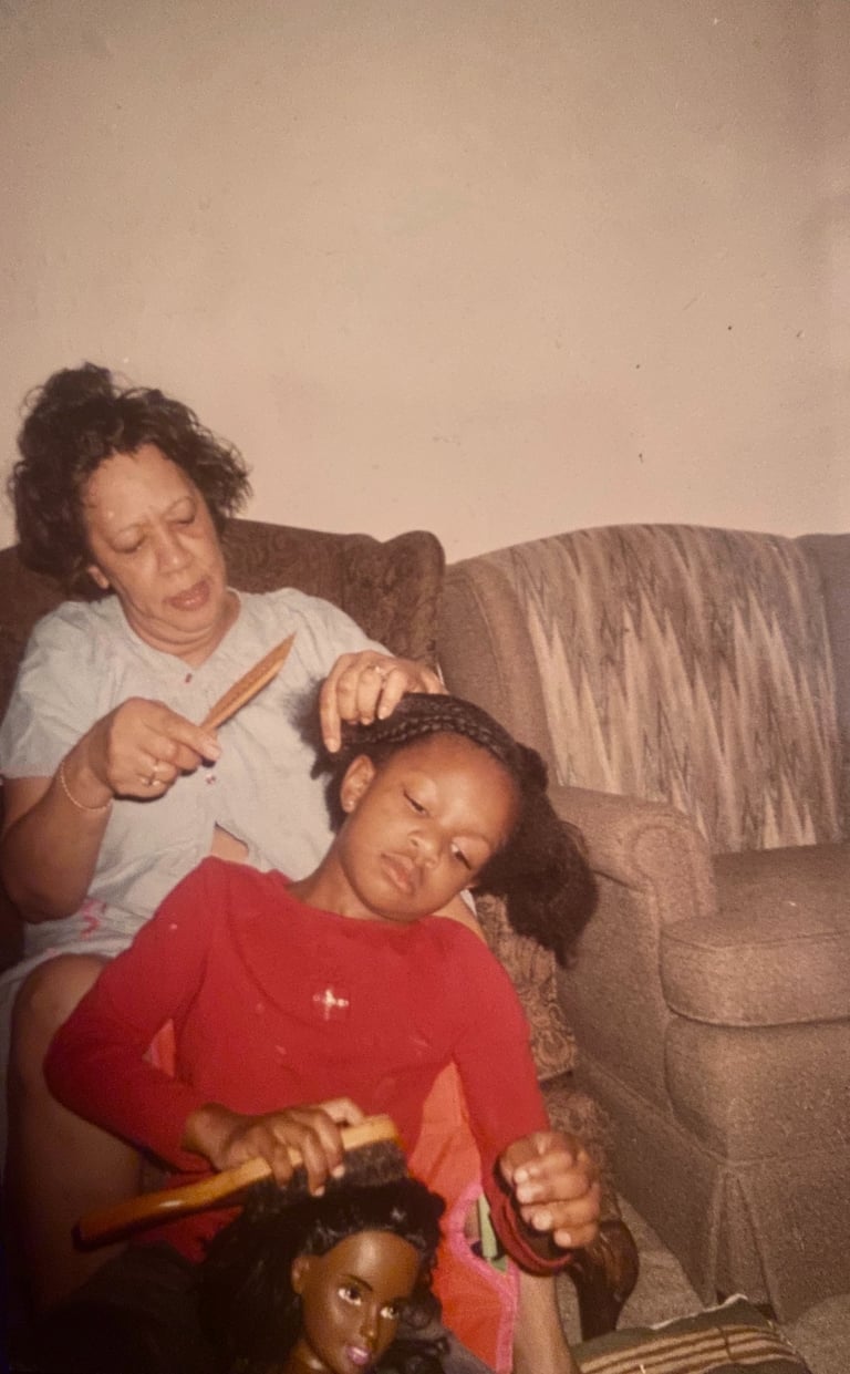 Granny braiding my hair while I braid a doll's hair