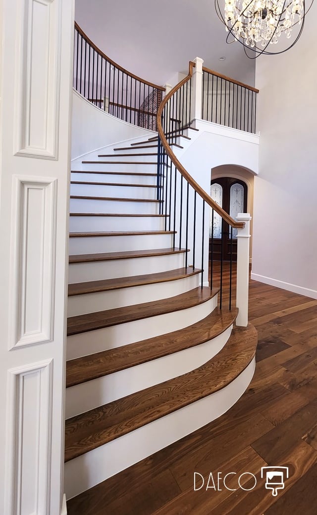 a staircase leading to a foyer with a chandelier - Denver Luxury Home Painting