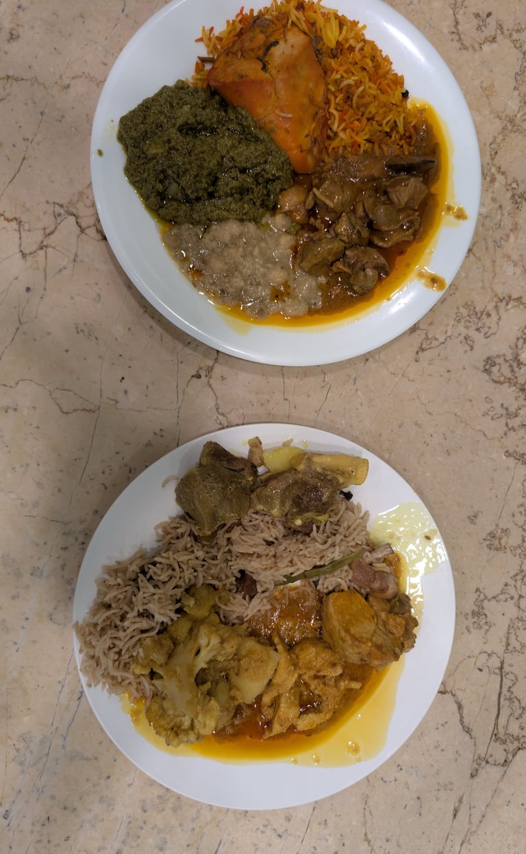 Authentic Pakistani dinner plates with basmati rice, lamb curry, saag, and spicy chicken biryani.
