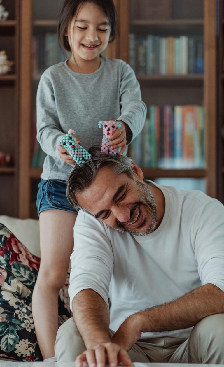 Father, sitting  on couch, playing with his daughter, in a luxury home - pexels