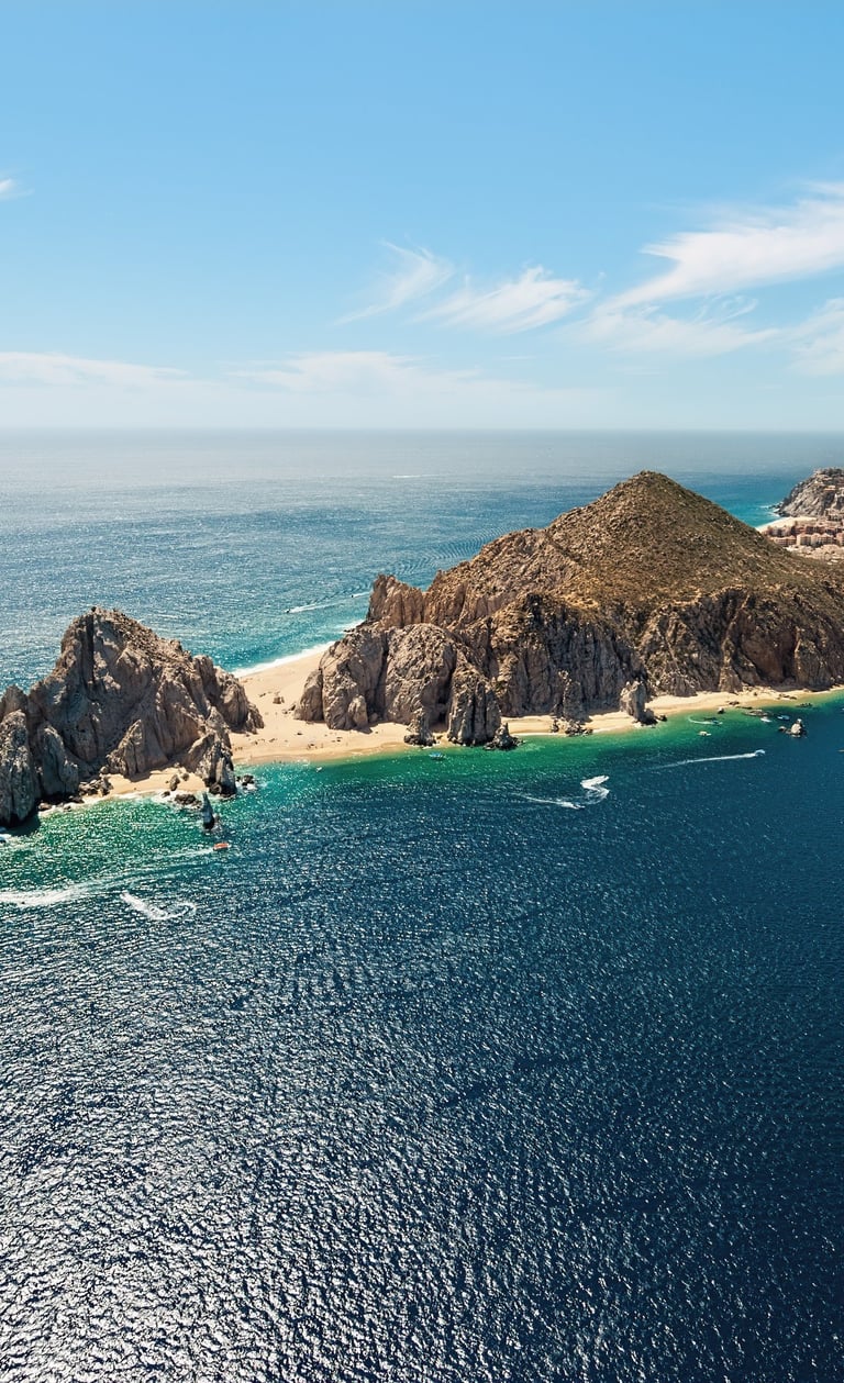 a group of boats sailing in the ocean