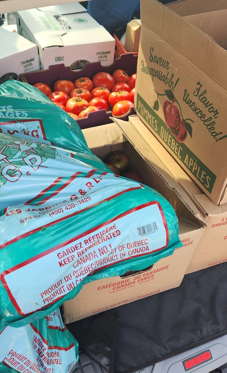 Boxes of produce and one of potatoes.