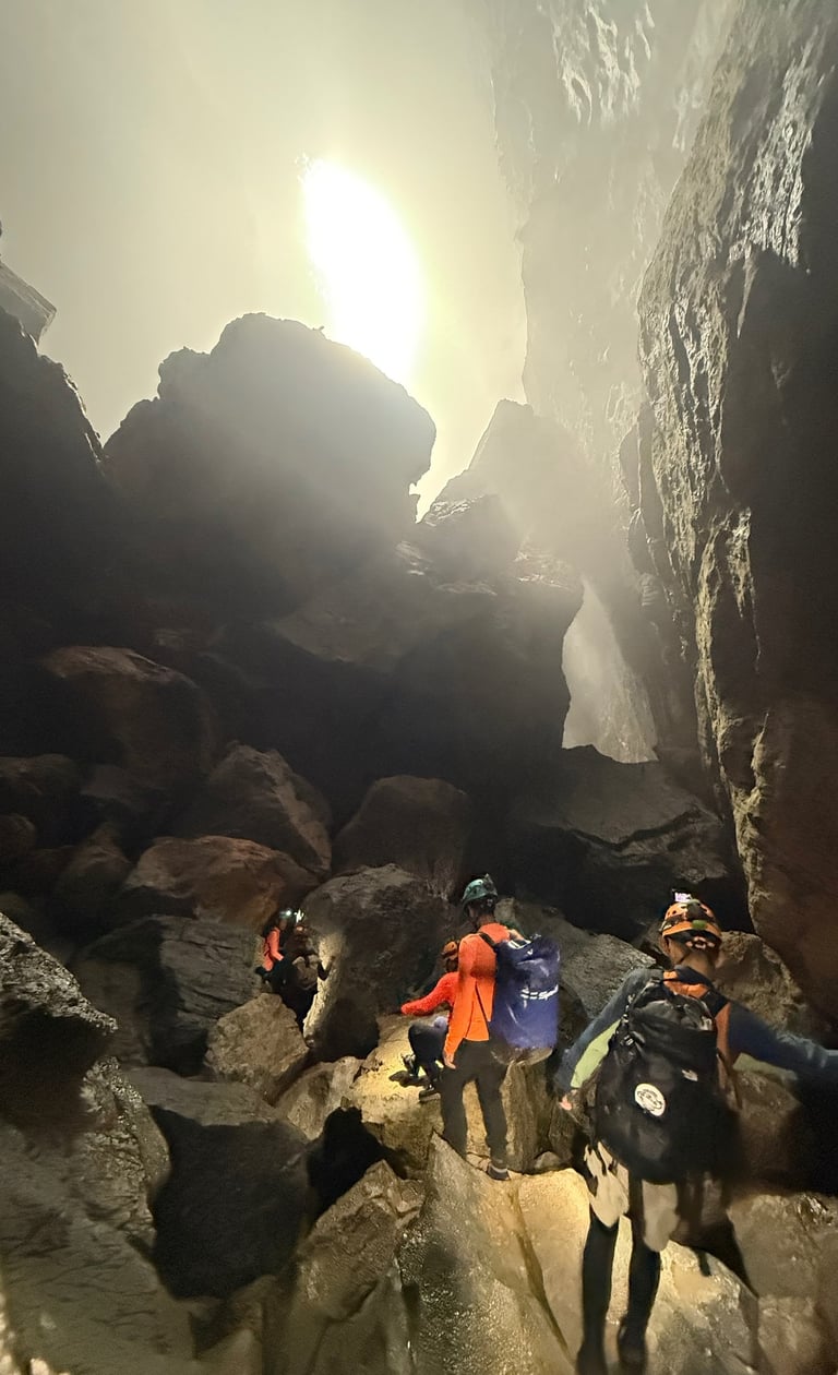 Tracey Billington climbing through a boulder field in Hang Son Doong Cave to get to doline 1