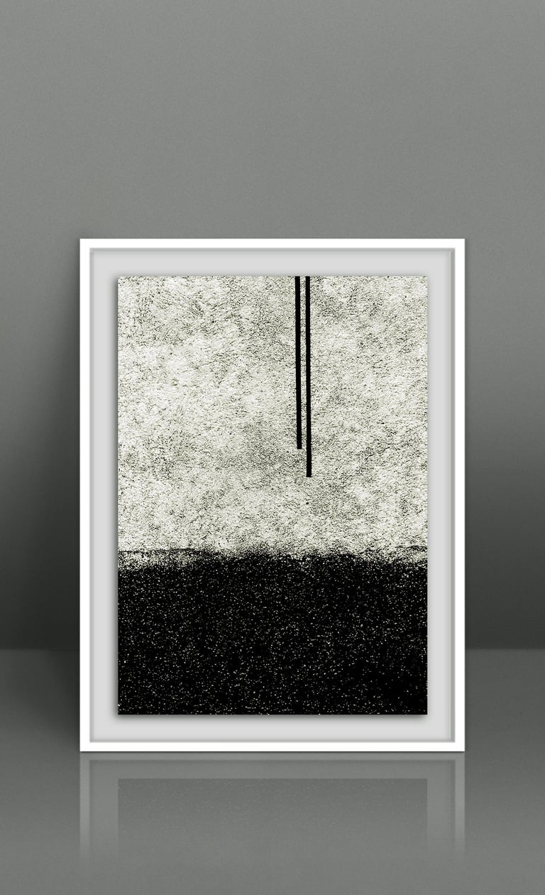 Minimalist black and white abstract wall art in a white frame, featuring a stippled landscape design.