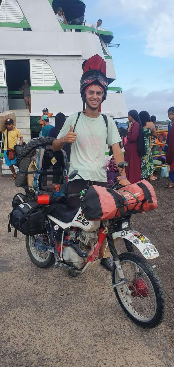 a man in a helmet and helmet on a motorcycle