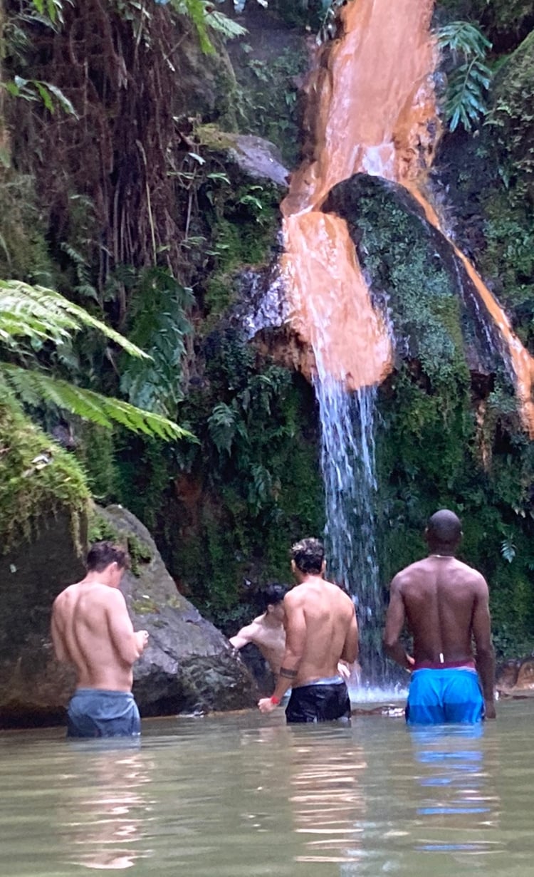 Men bathing together at a somatic bodywork event