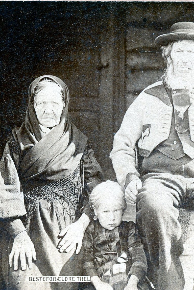 A black and white image of a man and a child in tradtitional costume