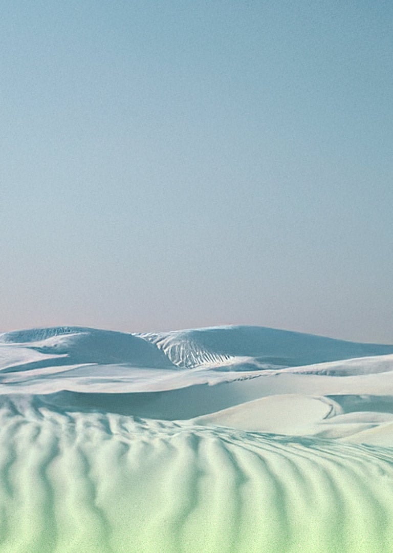 Landscape made of white sand dunes with a neutral blue sky