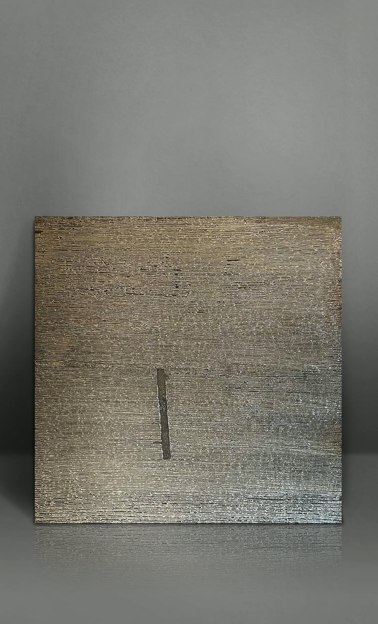 Textured metallic gold square art piece with a vertical slit on a gray minimalist background.
