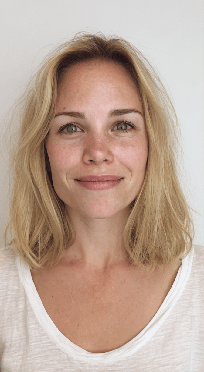 Soft champagne blonde colour transformation with long layered styling.
