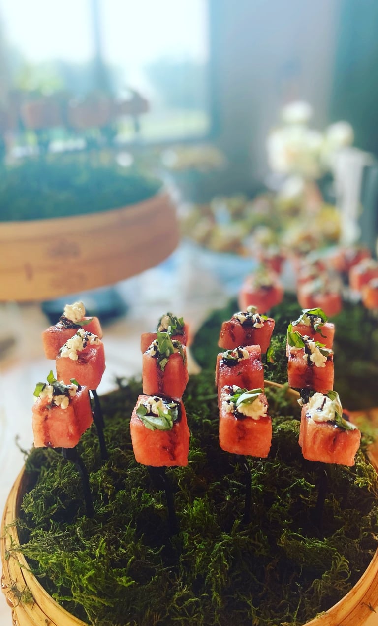 a table with a basket of sushiki and sushi canapes, displayed for a corporate happy hour event