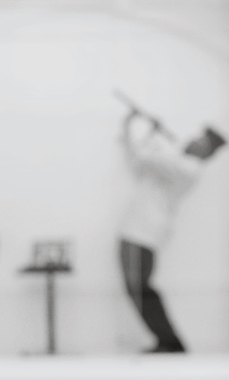 a man in a white shirt is playing the recorder