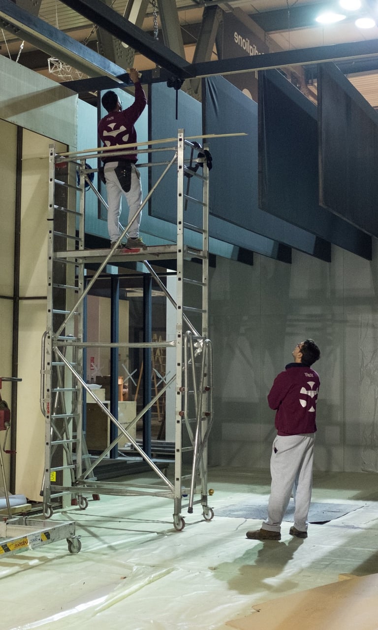 a man standing on a scaffold in a building