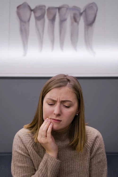 a woman with a toothbrush in her hand and a toothbrush in her hand