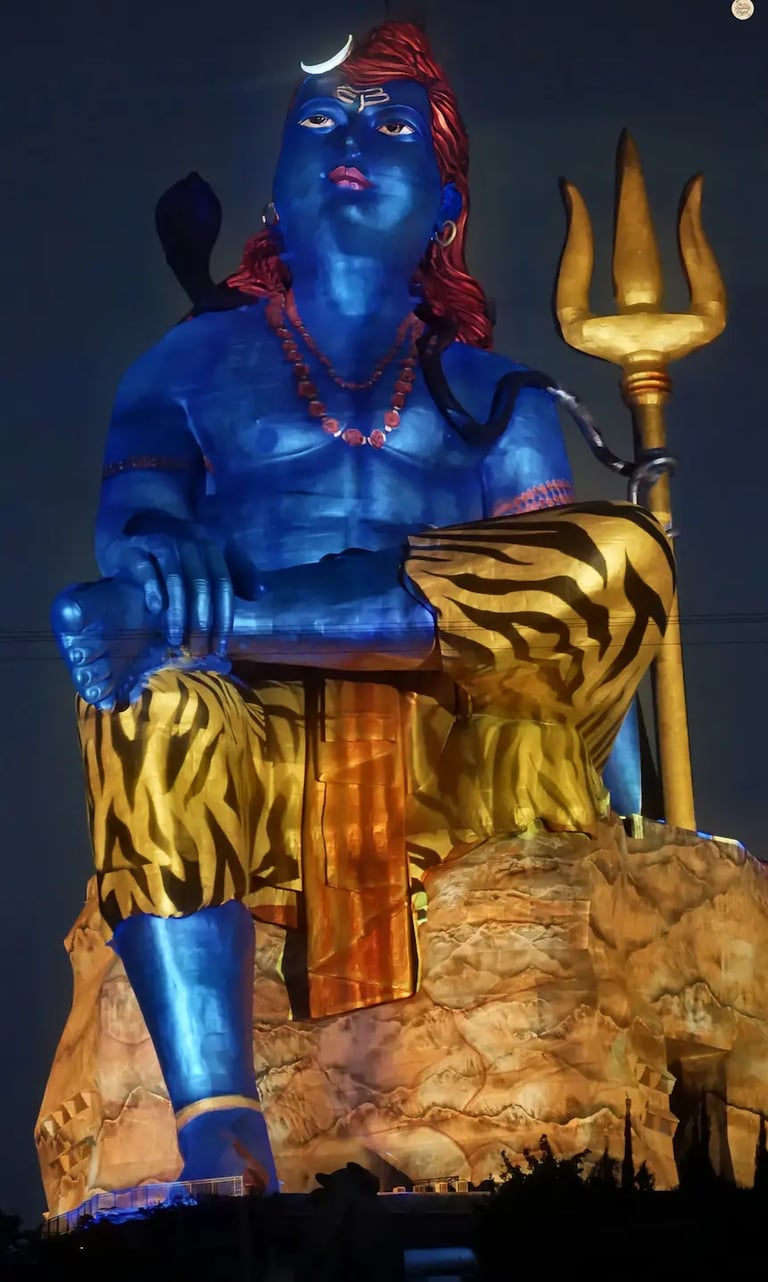 Light and sound show at Statue of Belief, illuminating the towering Shiva statue against the night sky.