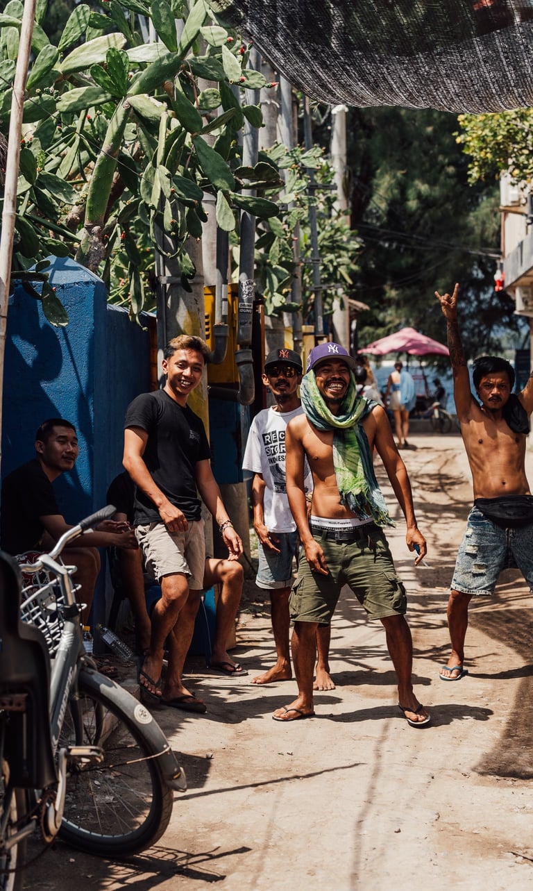 a group of indonesian people standing around a bicycle