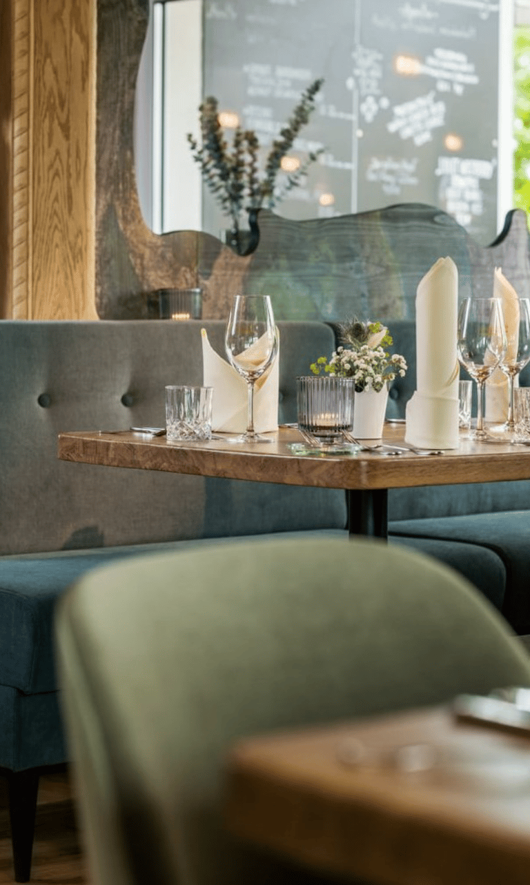 Modern restaurant interior with wooden tables and upholstered seating – BFS HORECA and public spaces furniture project.