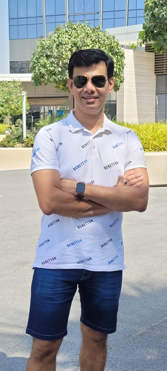 a man in a white shirt and blue shorts, raheel ahmed