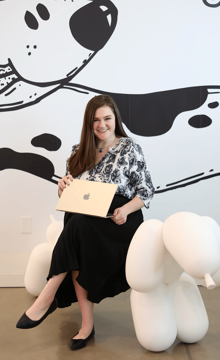 Marissa Wright with her laptop sitting on a giant baloon chair