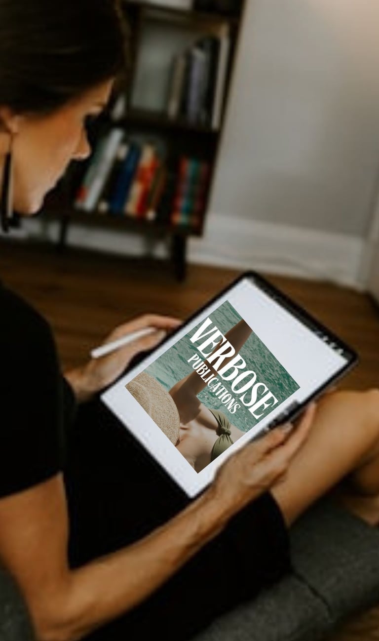 Woman holding a tablet while viewing Verbose Publications on her computer