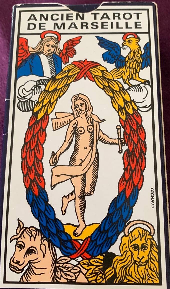 a tarot card deck with a picture of a man holding a sword